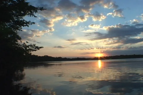 Lake Sunset sky with broken clouds- water reflections Video stock 125719938