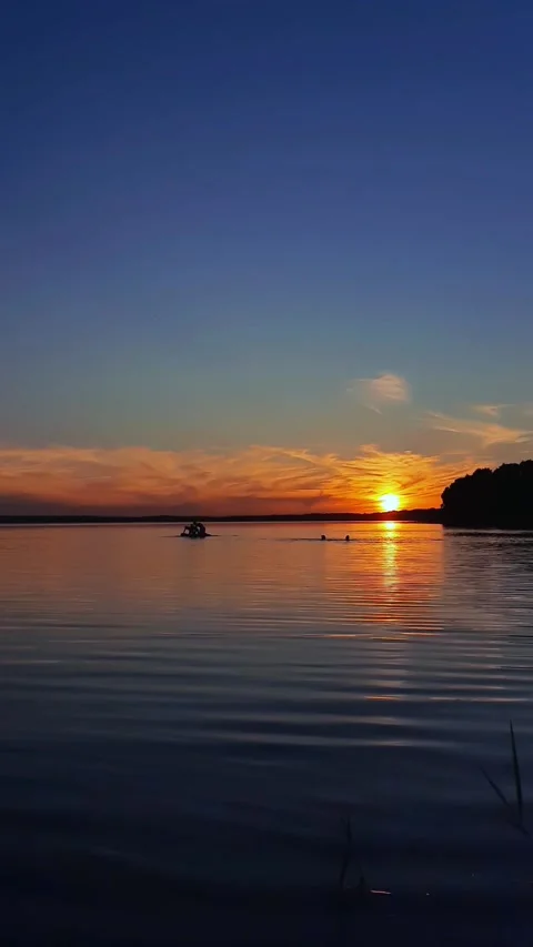 A lake at sunset with  in the water,  chill time. Stock Footage 280892333