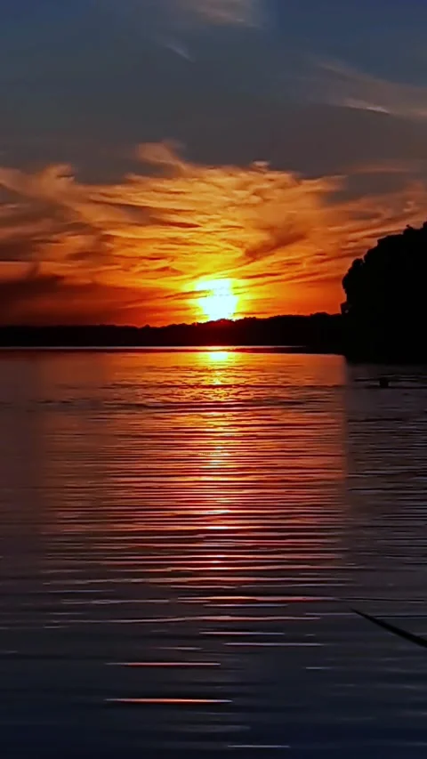 A lake at sunset with  in the water,  chill time. Stock Footage 280892358