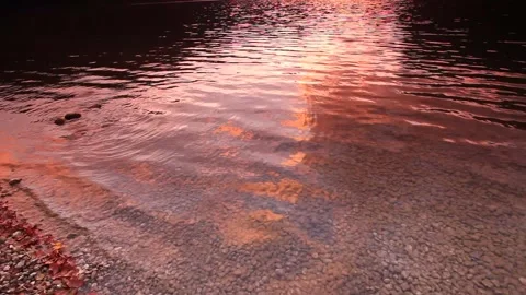 Lake surface at sunset Stock Footage 130893641