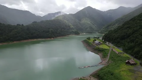 Lake surrounded by mountains Stock Footage 261273546