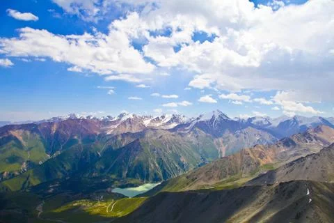 A lake surrounded by mountains Stock Photos