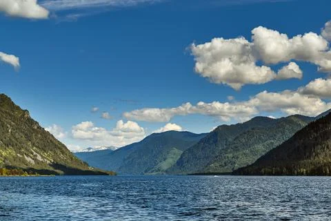 A lake surrounded by mountains Stock Photos