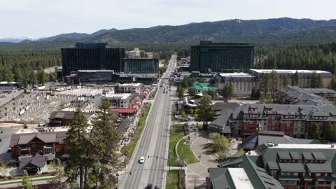 Lake Tahoe state border town with Harrah’s casino tower and alpine hotels Stock Footage 336503971
