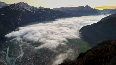 Lake Thun covered by clouds at sunset with part of Interlaken city Stock Footage 294281083