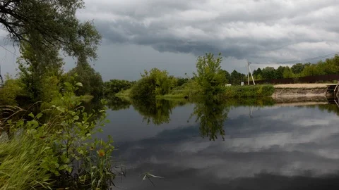 Lake time lapse shot of waves lapping on rocks and clouds forming in the evening Video stock 112988691