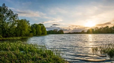 Lake timelapse with sunset behind clouds Stock Footage 50154022