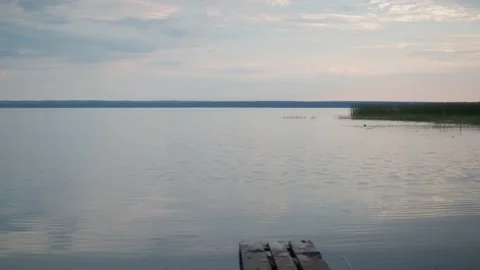 Lake tranquility. a small wave on the water. soft light from the setting sun Stock Footage 162412585