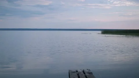 Lake tranquility. a small wave on the water. soft light from the setting sun Stock Footage 167694240