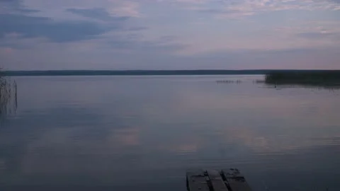 Lake tranquility. a small wave on the water. the soft light from the setting sun Stock Footage 167694245