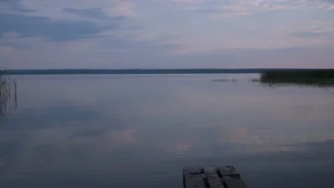 Lake tranquility. a small wave on the water. the soft light from the setting sun Stock Footage 168899413