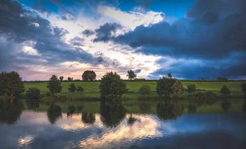 Lake with trees in the sunset Stock Photos