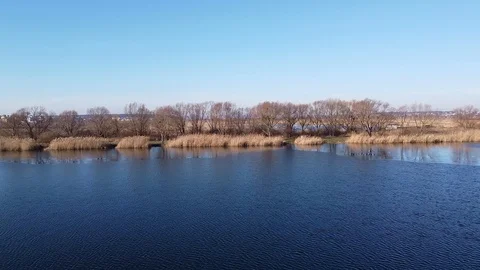 Lake under blue cloudy sky aero Stock Footage 122946991