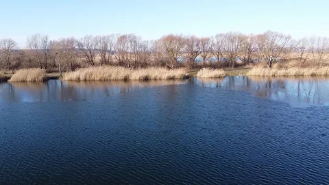 Lake under blue cloudy sky aero Stock Footage 122948852