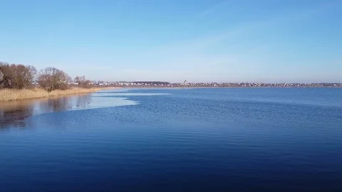 Lake under blue cloudy sky aero Stock Footage 122950442