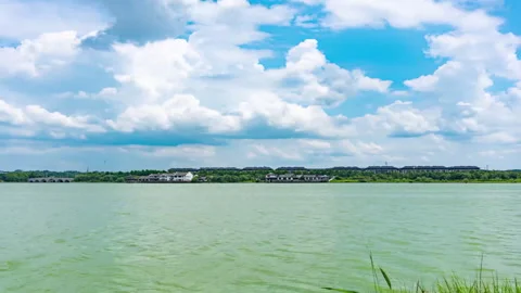 Lake under Blue Sky and White Clouds Timelapse Stock Footage 320813622
