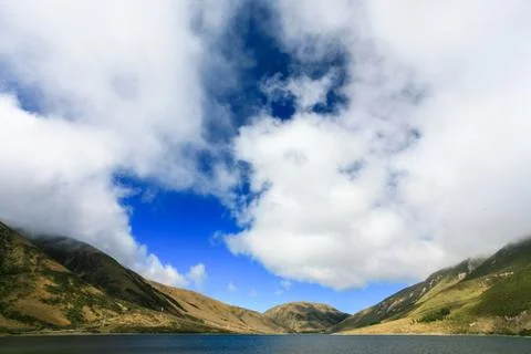 Lake under cloudy sky, new zealand Stock Photos