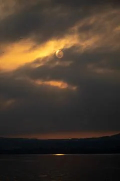 A lake view and gray clouds at sunrise Stock Photos