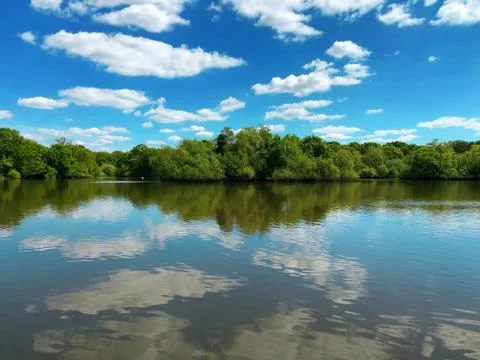Lake view with blue sky reflection on water, England. Stock Photos