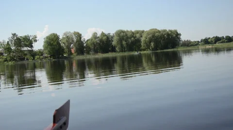 Lake view from boat blue surface of water trees fisherman boat Stock Footage 35665939