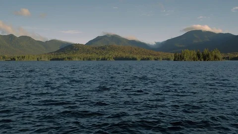 Lake water ripples with misty mountains in Distance. Adirondacks, NY. Stock Footage