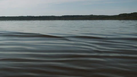 Lake water with small ripple on beautifu... | Stock Video | Pond5