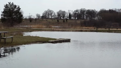 Lake of water in the spring fall with empty bench, 4k. Stock Footage 115273333