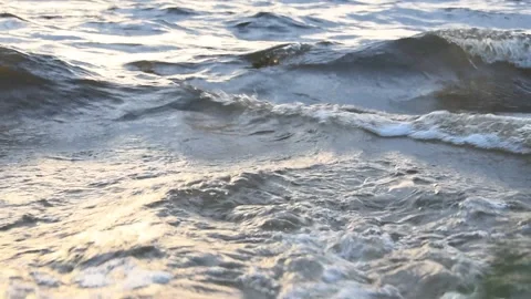 Lake waves in the sunset rays Stock Footage 273586693