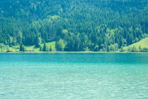 Lake Weissensee with a view of the forest upland Stock Photos