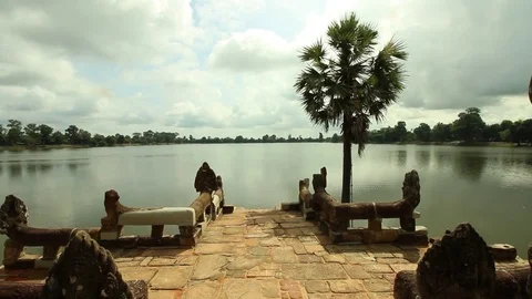 Lake within temple complex, Sras Srang. Tracking shot past lion guardians Stock Footage 76381350