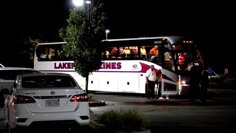 Lakefront charter bus line, senior tourists overnight hotel stop Video stock 80400161