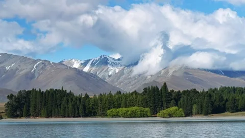 Lakes and snow-capped mountains on a sunny day Stock Footage 260883045
