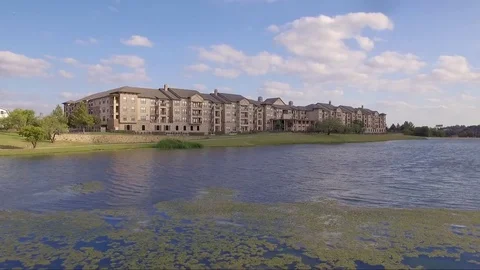 Lakeside Apartment Complex Fly Low Rise Up and Pan Across Stock Footage 76382158