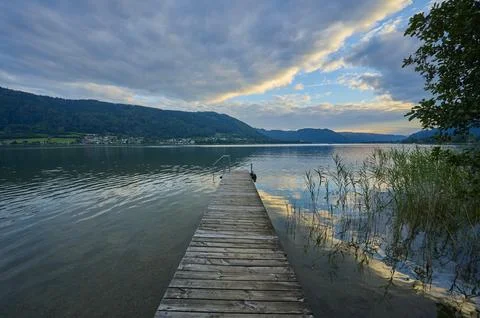 Lakeside bathing jetty sky clouds sunset summer Steindorf am Lake Ossiach Lake Stock Photos