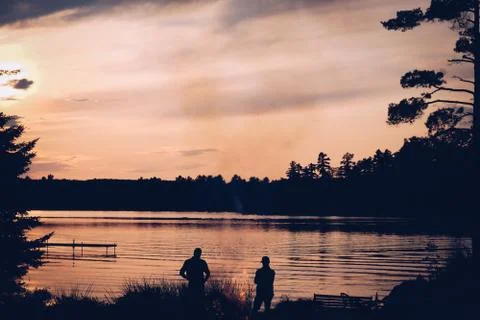 Lakeside building a campfire Stock Photos