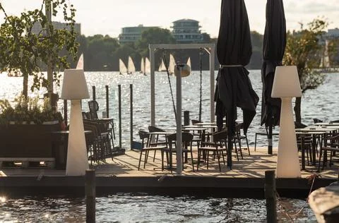 Lakeside Dining with Sailboats in the Background Stock Photos