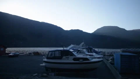 Lakeside Marina &amp; Construction Yard at Dusk with Naeroy Valley Mountains Stock Footage 341518175