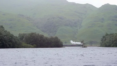 Lakeside Steam Train with Misty Mountain Scenery Loch Eilt Scotland Stock Footage 100239060
