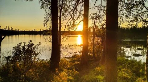 Lakeside sunset in midsummer Stock Photos
