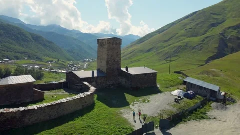 Lamaria monastery complex dominating ushguli landscape georgia Stock Footage 301234917