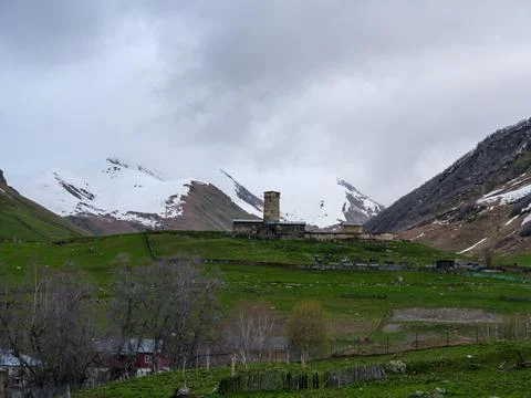 Lamaria Monastery Svan tower under gloomy overcast sky in Ushguli Stock Photos