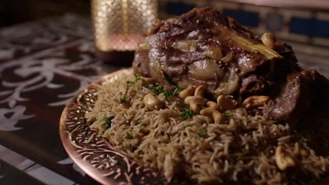 Lamb and Rice Pilaf with Nuts Served on Ornate Plate in Traditional Turkish Stock Footage 345953326