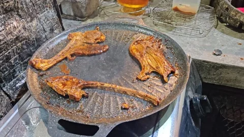 Lamb Chop Cooking on Hot Iron Pan with Sizzling Oil Stock-Footage 323908982