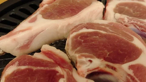 Lamb chops on a barbecue plate during a BBQ Stock Footage 232103061