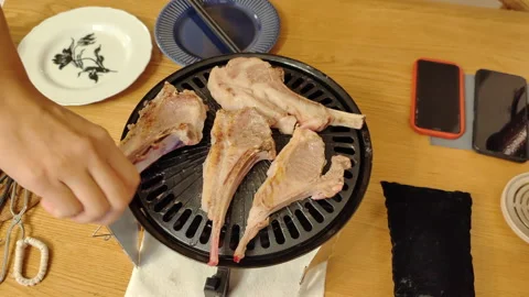 Lamb chops on a barbecue plate during a BBQ Stock Footage 232104863