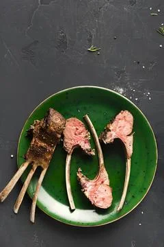 Lamb chops on a green plate ready to eat Stock Photos