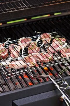 Lamb chops in grilling basket on grill Stock Photos