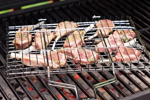 Lamb chops in grilling basket on grill Stock Photos