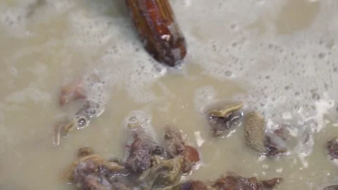 Lamb curry, cooking over fire, hot until boiling in large pan, authentic detail Stock Footage 293179111