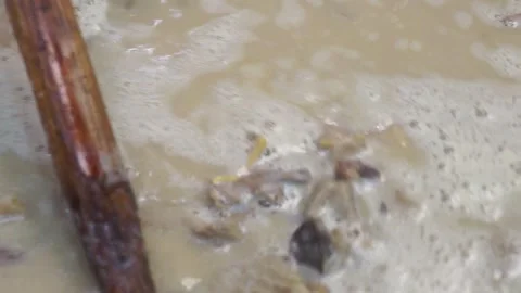 Lamb curry, cooking over fire, hot until boiling in large pan, authentic detail Stock Footage 293179112